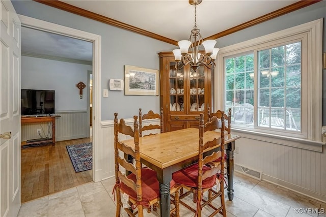 10903 Gayton Rd, Henrico, VA 23238 - dining room with wainscoting, a chandelier, healthy amount of natural light, crown molding, and light tile patterned flooring