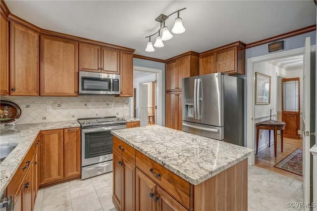10903 Gayton Rd, Henrico, VA 23238 - kitchen featuring stainless steel appliances, brown cabinetry, tasteful backsplash, and ornamental molding