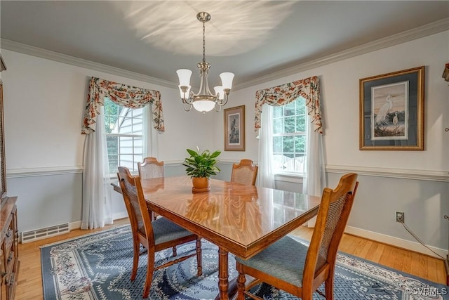 10903 Gayton Rd, Henrico, VA 23238 - dining room with healthy amount of natural light, crown molding, a chandelier, and light wood-style flooring