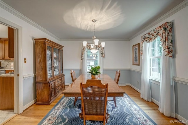 10903 Gayton Rd, Henrico, VA 23238 - dining space with healthy amount of natural light, a chandelier, light wood-type flooring, and crown molding