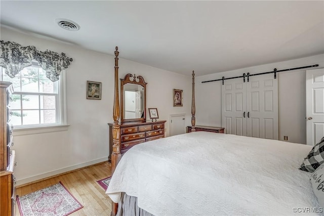 10903 Gayton Rd, Henrico, VA 23238 - bedroom featuring light wood-type flooring and a barn door