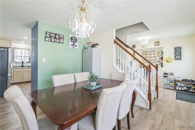 3706 Paul Karnes Dr, Hopewell, VA 23860 - dining room featuring light wood-style flooring, stairway, and a chandelier