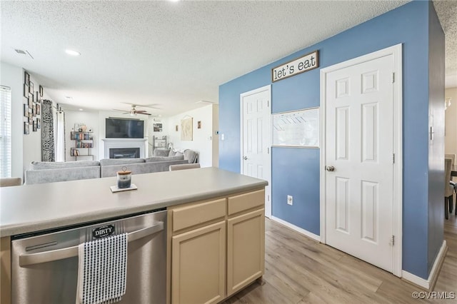 3706 Paul Karnes Dr, Hopewell, VA 23860 - kitchen with dishwasher, a ceiling fan, light wood finished floors, a textured ceiling, and light countertops