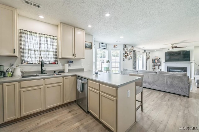 3706 Paul Karnes Dr, Hopewell, VA 23860 - kitchen with dishwasher, a textured ceiling, a peninsula, a ceiling fan, and light countertops