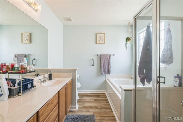 3706 Paul Karnes Dr, Hopewell, VA 23860 - full bath with vanity, wood finished floors, a garden tub, and a shower stall