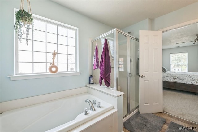 3706 Paul Karnes Dr, Hopewell, VA 23860 - ensuite bathroom featuring a stall shower, a garden tub, and wood finished floors