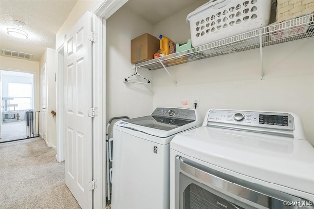 3706 Paul Karnes Dr, Hopewell, VA 23860 - laundry room with light carpet, washing machine and dryer, and a textured ceiling