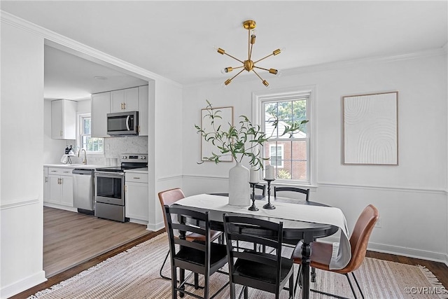 1908 Windsordale Dr, Henrico, VA 23229 - dining area featuring wood finished floors, a chandelier, and crown molding