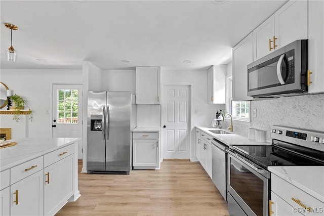 1908 Windsordale Dr, Henrico, VA 23229 - kitchen featuring stainless steel appliances, decorative backsplash, white cabinetry, and light wood-type flooring