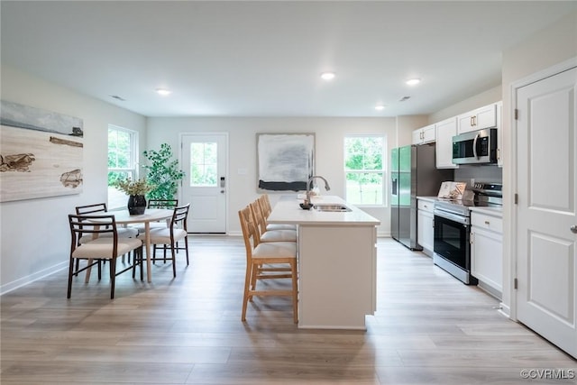 14645 Hancock Towns Dr Unit P-5, Chesterfield, VA 23832 - kitchen with appliances with stainless steel finishes, a kitchen breakfast bar, healthy amount of natural light, white cabinets, and recessed lighting