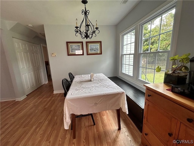 6033 Ironworks Ct, Mechanicsville, VA 23111 - dining room with wood finished floors and a chandelier