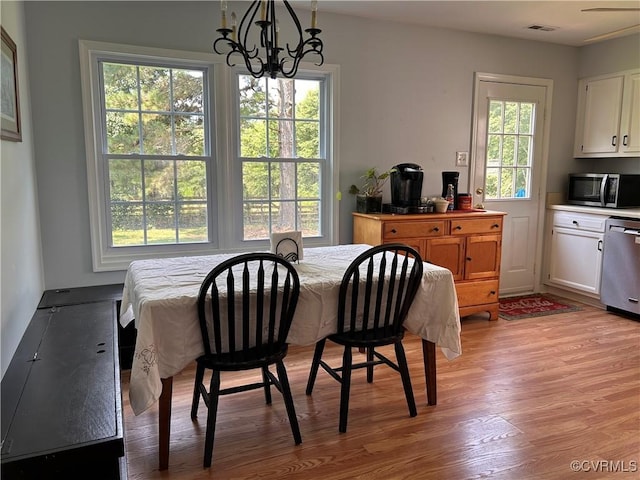 6033 Ironworks Ct, Mechanicsville, VA 23111 - dining space with light wood-style floors and a chandelier