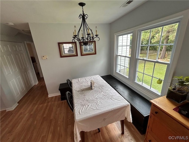 6033 Ironworks Ct, Mechanicsville, VA 23111 - dining space featuring dark wood-style flooring and a chandelier