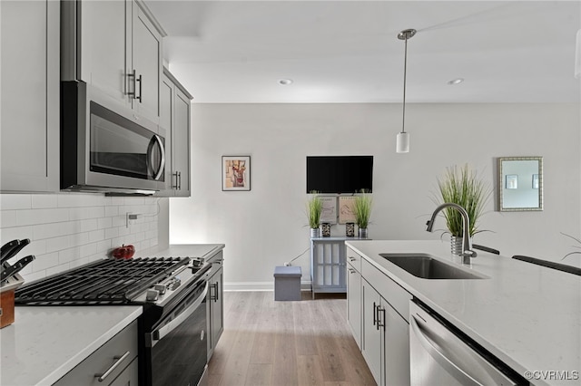 7001 Leire Ln, Chesterfield, VA 23832 - kitchen featuring stainless steel appliances, light stone countertops, tasteful backsplash, light wood-style floors, and recessed lighting
