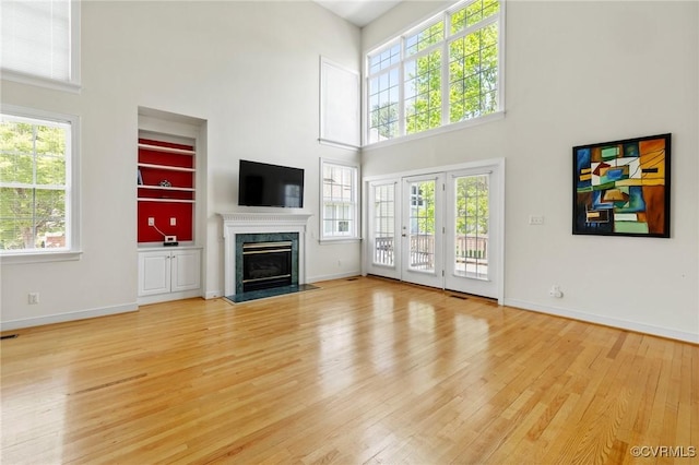 5908 Dominion Fairways Ct, Glen Allen, VA 23059 - unfurnished living room featuring a high ceiling, light wood-style flooring, and a premium fireplace