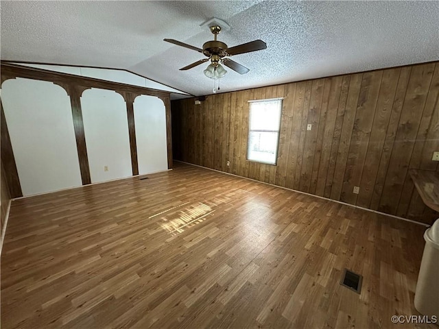 2305 Swift Bluff Dr, South Chesterfield, VA 23834 - spare room with a ceiling fan, wood finished floors, a textured ceiling, vaulted ceiling, and wood walls