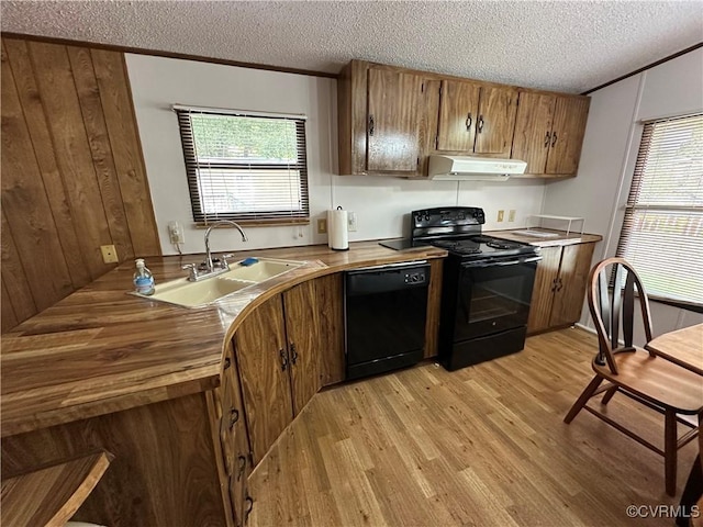 2305 Swift Bluff Dr, South Chesterfield, VA 23834 - kitchen featuring black appliances, light wood-style floors, brown cabinets, under cabinet range hood, and a textured ceiling