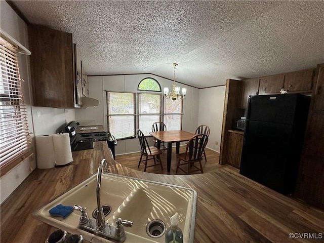 2305 Swift Bluff Dr, South Chesterfield, VA 23834 - kitchen featuring black appliances, dark wood-type flooring, vaulted ceiling, a chandelier, and a textured ceiling
