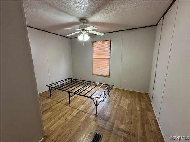 2305 Swift Bluff Dr, South Chesterfield, VA 23834 - unfurnished bedroom with wood finished floors, a textured ceiling, and ceiling fan