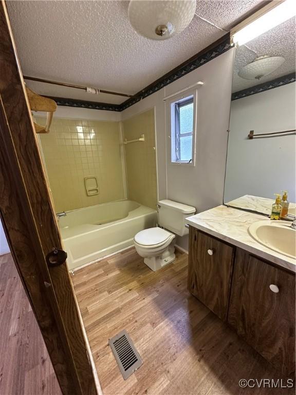 2305 Swift Bluff Dr, South Chesterfield, VA 23834 - full bath featuring vanity, wood finished floors, washtub / shower combination, and a textured ceiling