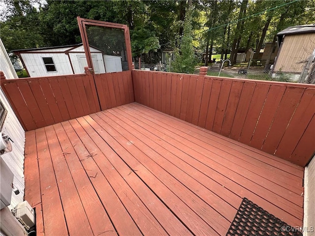2305 Swift Bluff Dr, South Chesterfield, VA 23834 - deck featuring a storage unit and view of scattered trees