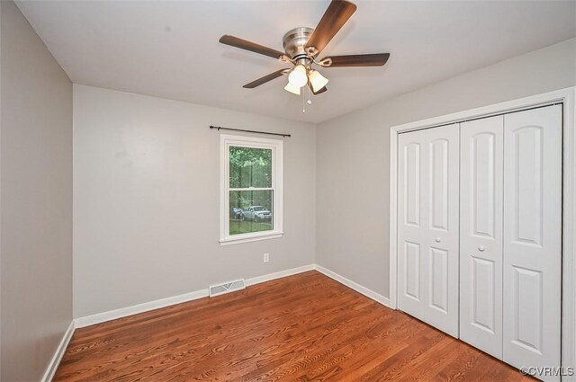 2131 Highland Dr, Powhatan, VA 23139 - unfurnished bedroom with wood finished floors, a closet, and a ceiling fan