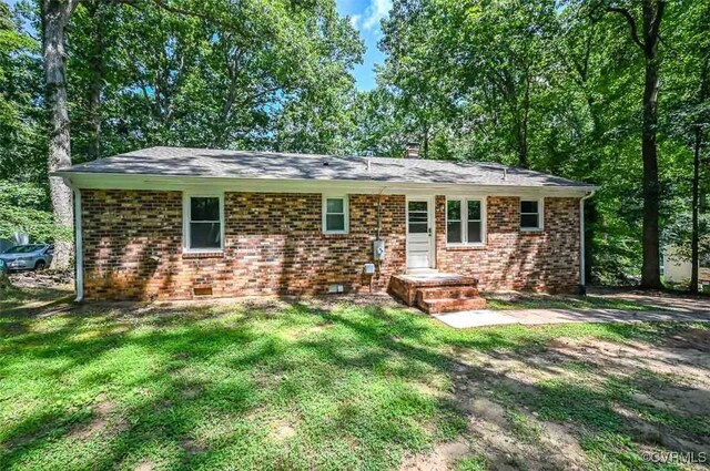2131 Highland Dr, Powhatan, VA 23139 - view of front of house with a front lawn, brick siding, and a chimney