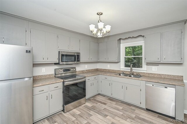 2131 Highland Dr, Powhatan, VA 23139 - kitchen featuring stainless steel appliances, a chandelier, light wood-type flooring, pendant lighting, and light countertops
