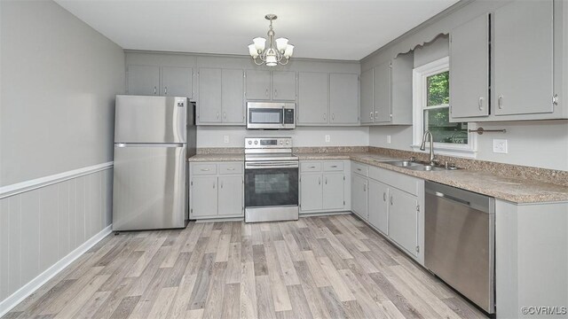 2131 Highland Dr, Powhatan, VA 23139 - kitchen featuring stainless steel appliances, light wood finished floors, a chandelier, light countertops, and gray cabinetry