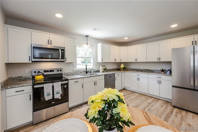 4300 N Courthouse Rd, Providence Forge, VA 23140 - kitchen with stainless steel appliances, white cabinetry, light wood-type flooring, decorative light fixtures, and recessed lighting