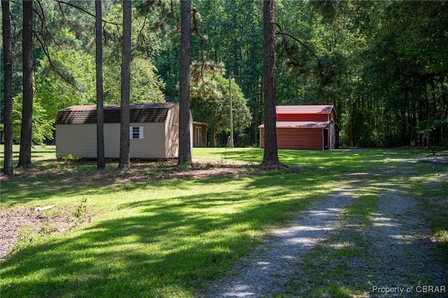 844 Rocky Point Lndg, Cobbs Creek, VA 23035 - view of green lawn featuring a shed, driveway, and a view of trees