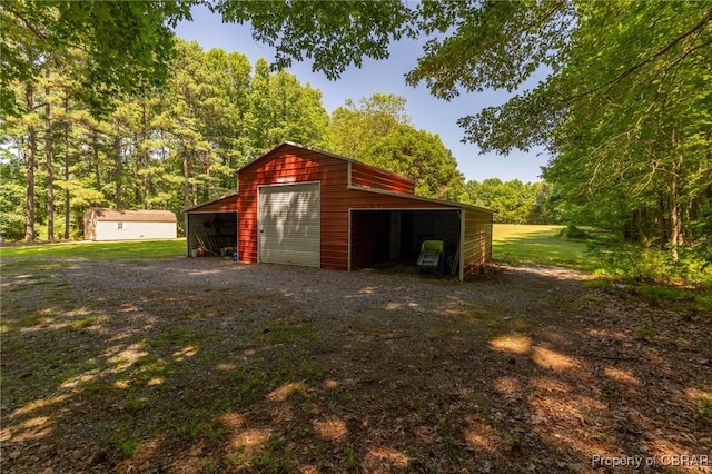 844 Rocky Point Lndg, Cobbs Creek, VA 23035 - garage with a detached garage and a view of trees
