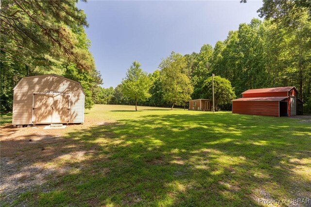 844 Rocky Point Lndg, Cobbs Creek, VA 23035 - view of grassy yard with a storage shed