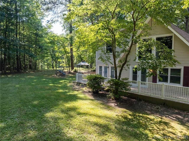 844 Rocky Point Lndg, Cobbs Creek, VA 23035 - view of grassy yard with french doors and a deck
