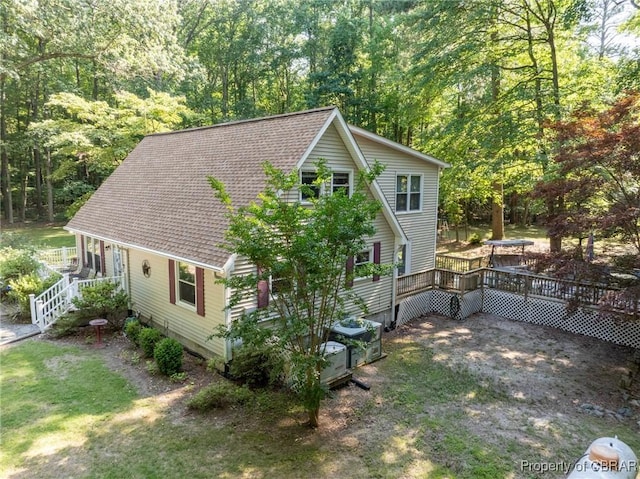 844 Rocky Point Lndg, Cobbs Creek, VA 23035 - view of front of house featuring a wooden deck, a view of trees, and roof with shingles