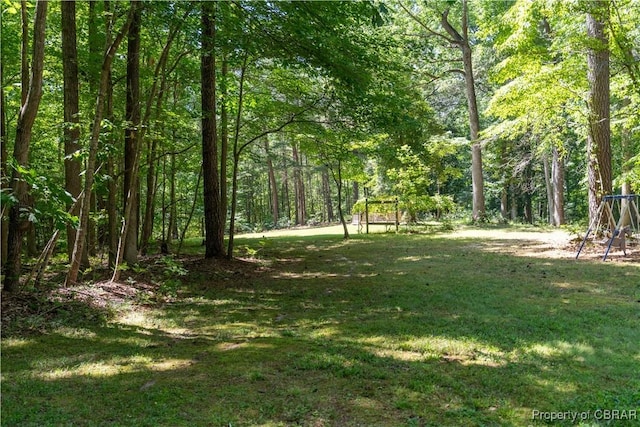844 Rocky Point Lndg, Cobbs Creek, VA 23035 - view of green lawn with a wooded view