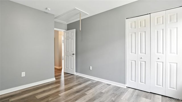 566 Abbey Village Cir, Midlothian, VA 23114 - unfurnished bedroom with attic access, wood finished floors, and a closet