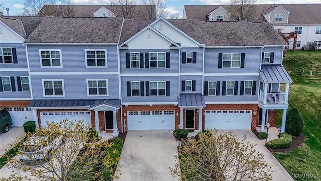 566 Abbey Village Cir, Midlothian, VA 23114 - view of property featuring brick siding, driveway, an attached garage, and a standing seam roof
