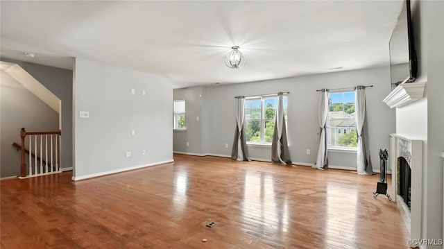 566 Abbey Village Cir, Midlothian, VA 23114 - unfurnished living room with a fireplace and light wood-style flooring