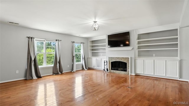 566 Abbey Village Cir, Midlothian, VA 23114 - unfurnished living room with wood finished floors, a fireplace, and built in shelves