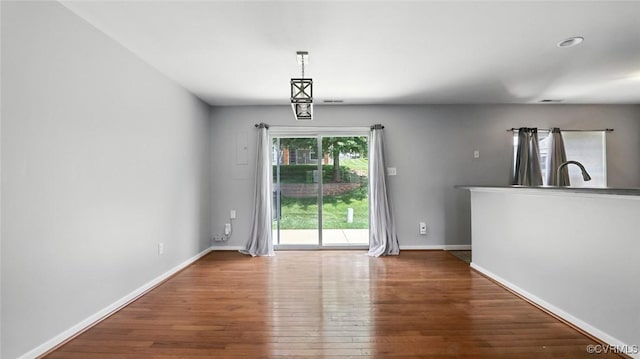 566 Abbey Village Cir, Midlothian, VA 23114 - unfurnished dining area with wood finished floors and baseboards