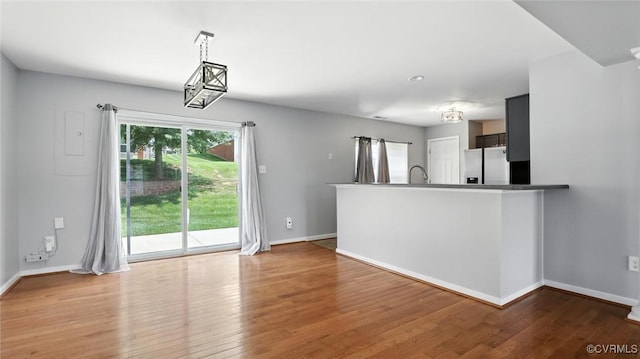 566 Abbey Village Cir, Midlothian, VA 23114 - kitchen featuring stainless steel fridge, wood finished floors, a peninsula, and decorative light fixtures