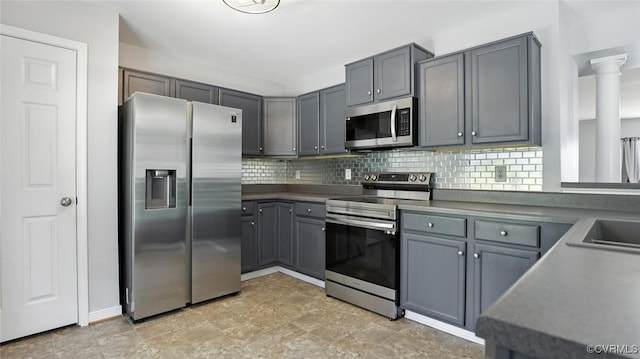 566 Abbey Village Cir, Midlothian, VA 23114 - kitchen featuring stainless steel appliances, decorative backsplash, gray cabinetry, and ornate columns