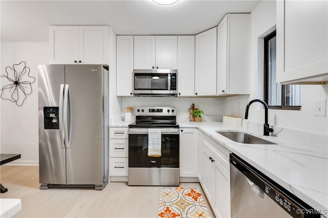 11904 W Briar Patch Dr, Midlothian, VA 23113 - kitchen with stainless steel appliances, white cabinets, light stone countertops, and light wood-style floors