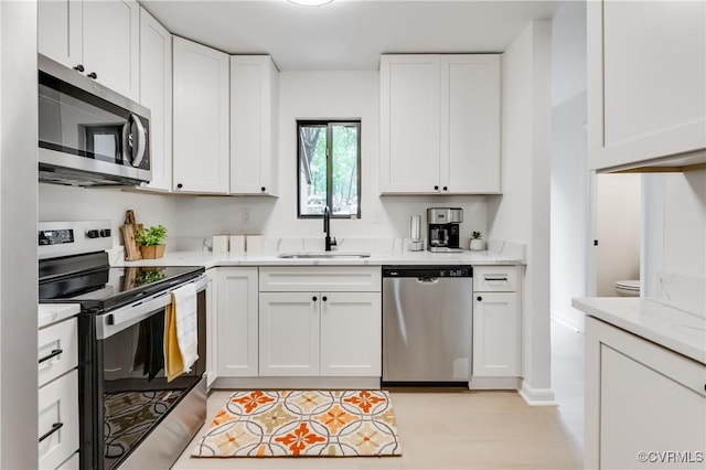 11904 W Briar Patch Dr, Midlothian, VA 23113 - kitchen with appliances with stainless steel finishes, white cabinets, and light stone countertops