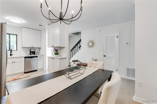 11904 W Briar Patch Dr, Midlothian, VA 23113 - dining area with a chandelier, light wood-type flooring, and stairs
