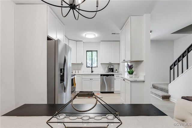 11904 W Briar Patch Dr, Midlothian, VA 23113 - kitchen with appliances with stainless steel finishes, a chandelier, white cabinets, and light countertops