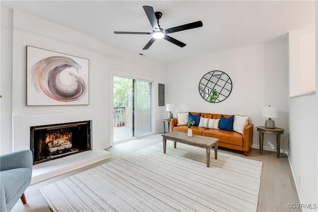 11904 W Briar Patch Dr, Midlothian, VA 23113 - living room featuring wood finished floors, a ceiling fan, a brick fireplace, and electric panel