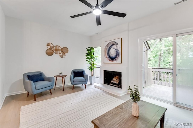 11904 W Briar Patch Dr, Midlothian, VA 23113 - living area featuring wood finished floors, a warm lit fireplace, and ceiling fan