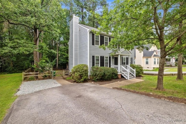 12628 Copperas Ln, Richmond, VA 23233 - colonial inspired home featuring a chimney, a front lawn, and driveway